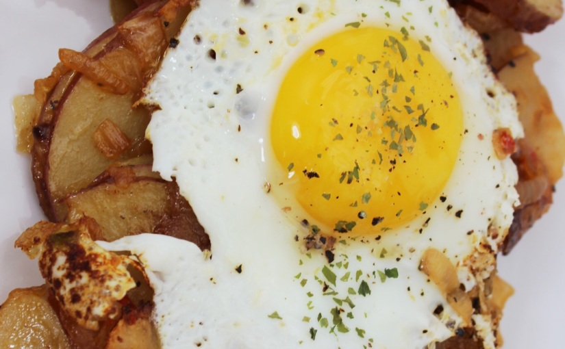 Breakfast potatoes with fried egg